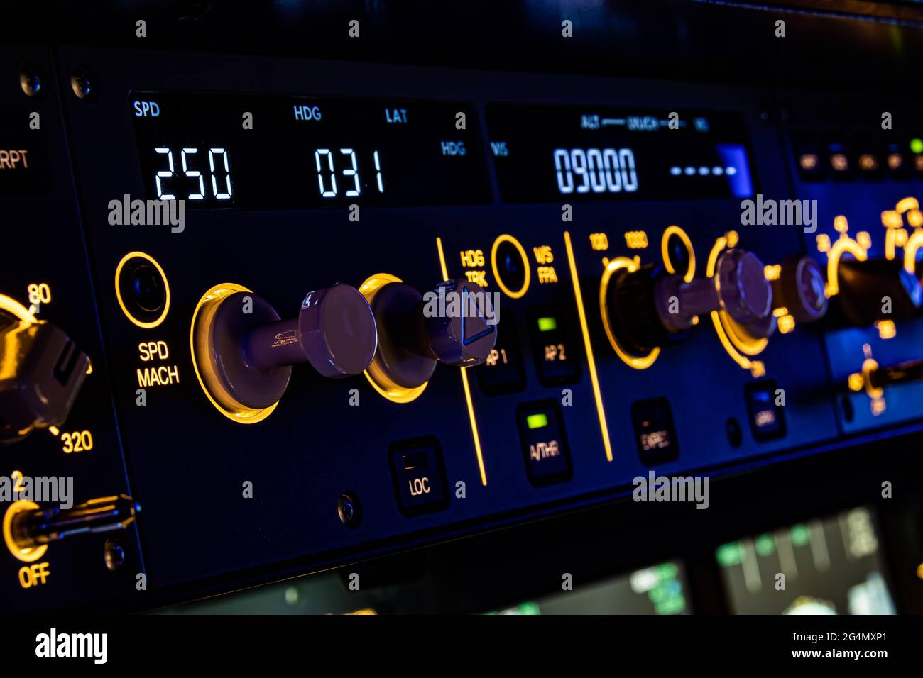 The Flight Control Unit of an commercial aircraft, with various knows and switches to control the aircraft systems. Stock Photo