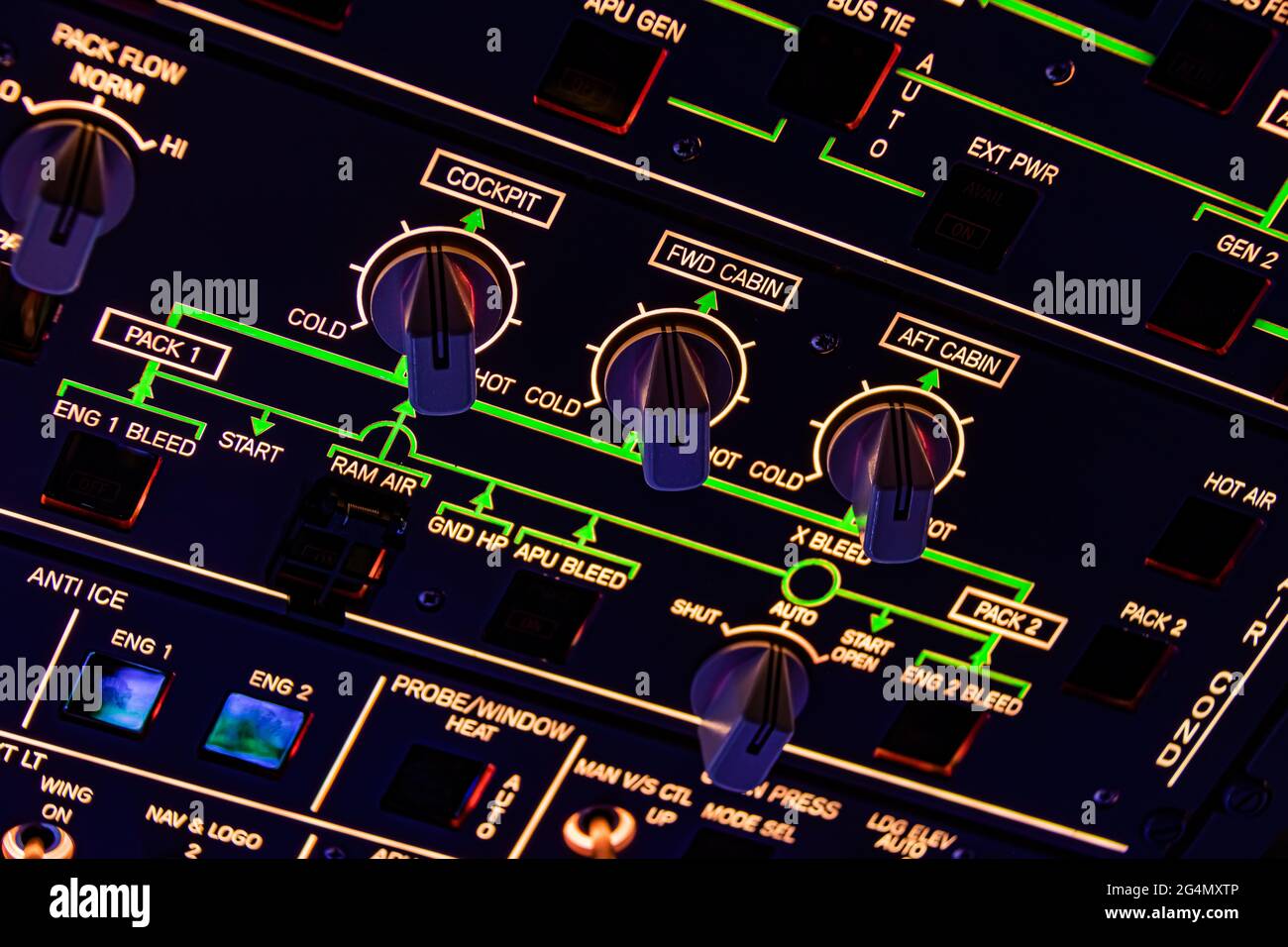 A close up of the overhead panel of a commercial airplane, with countless switches and buttons for controlling various aircraft systems and components Stock Photo