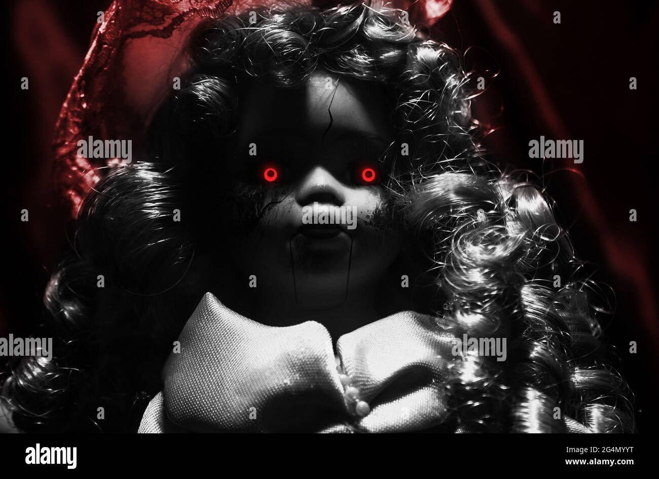 Horror photo of scary demon possessed plastic doll with glowing red eyes on  dark background Stock Photo - Alamy