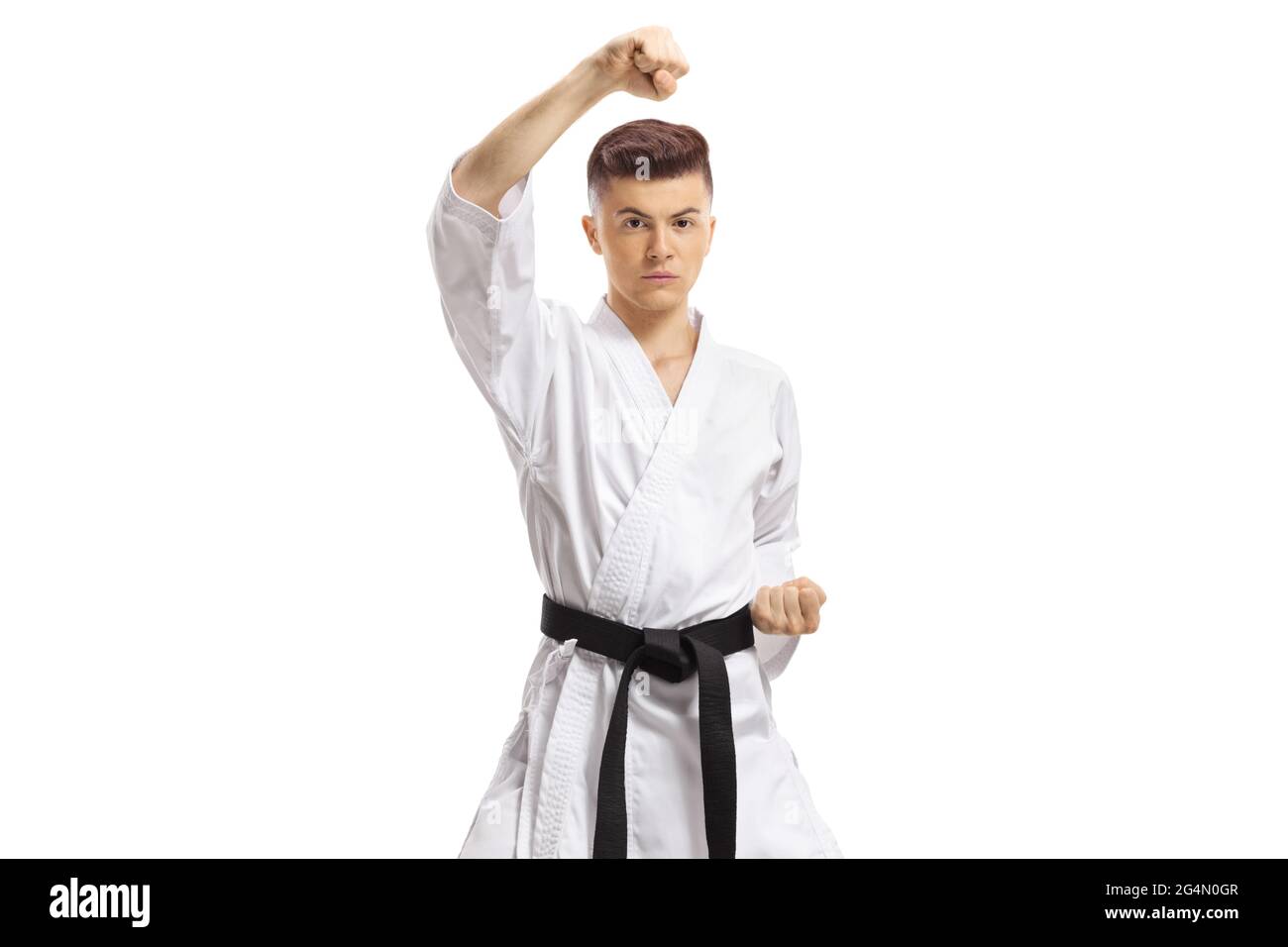 Guy in kimono exercising block technique in martial arts isolated on