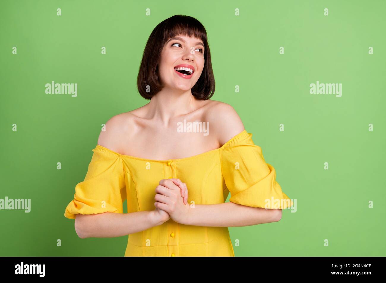 Portrait of attractive cheerful amazed girl having fun good news isolated over green color background Stock Photo