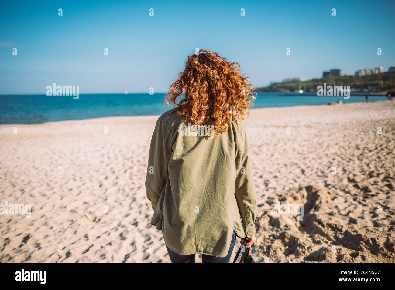 Young woman wearing casual outfit goes 