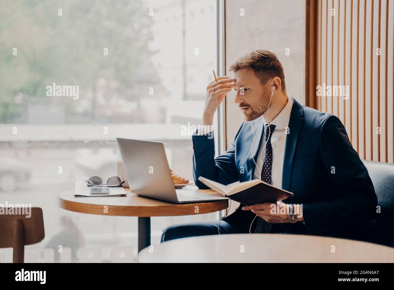Side photo of successful business person busy working from coffee shop Stock Photo