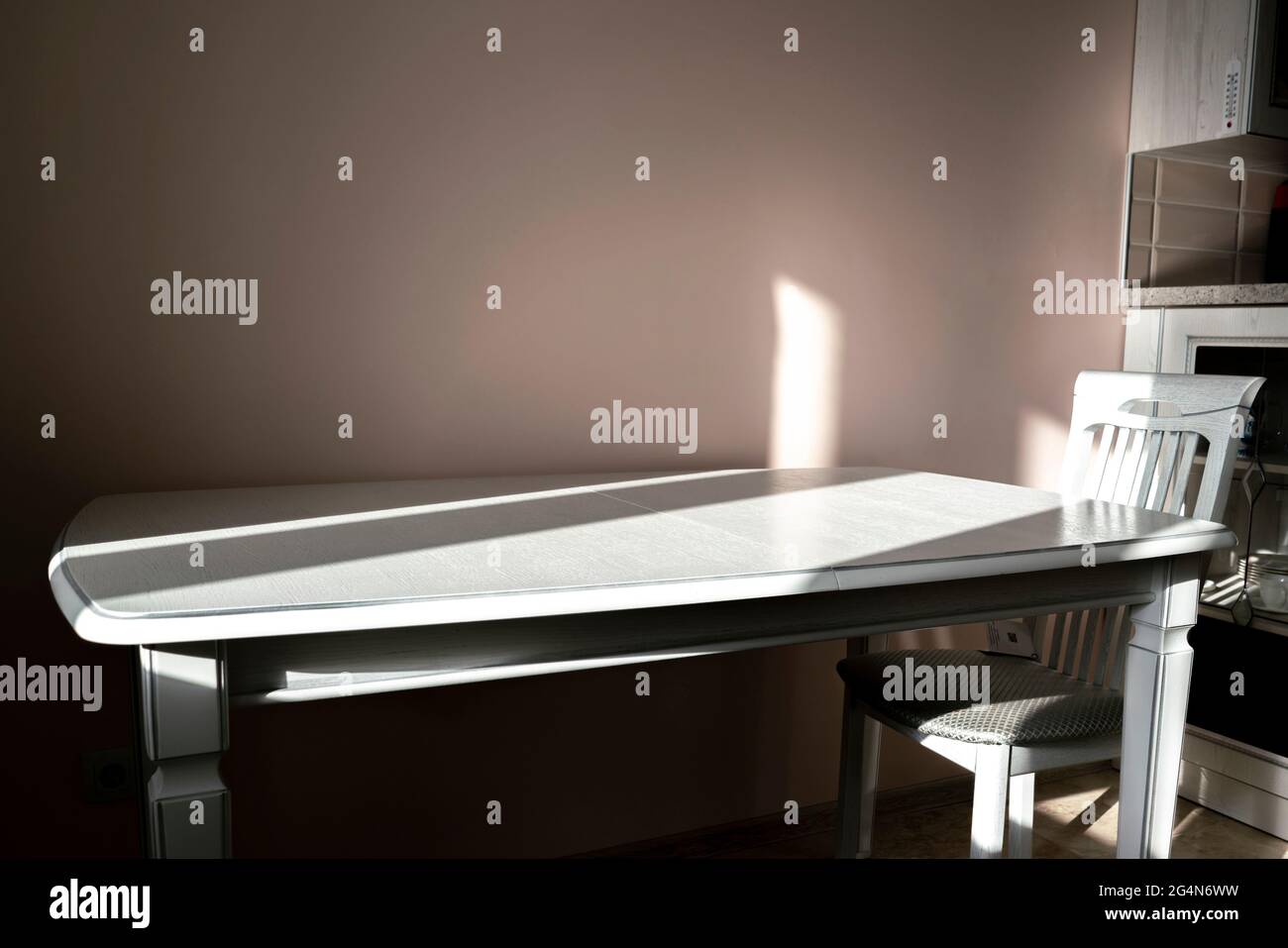 abstract kitchen table and chair design with hard shadows Stock Photo