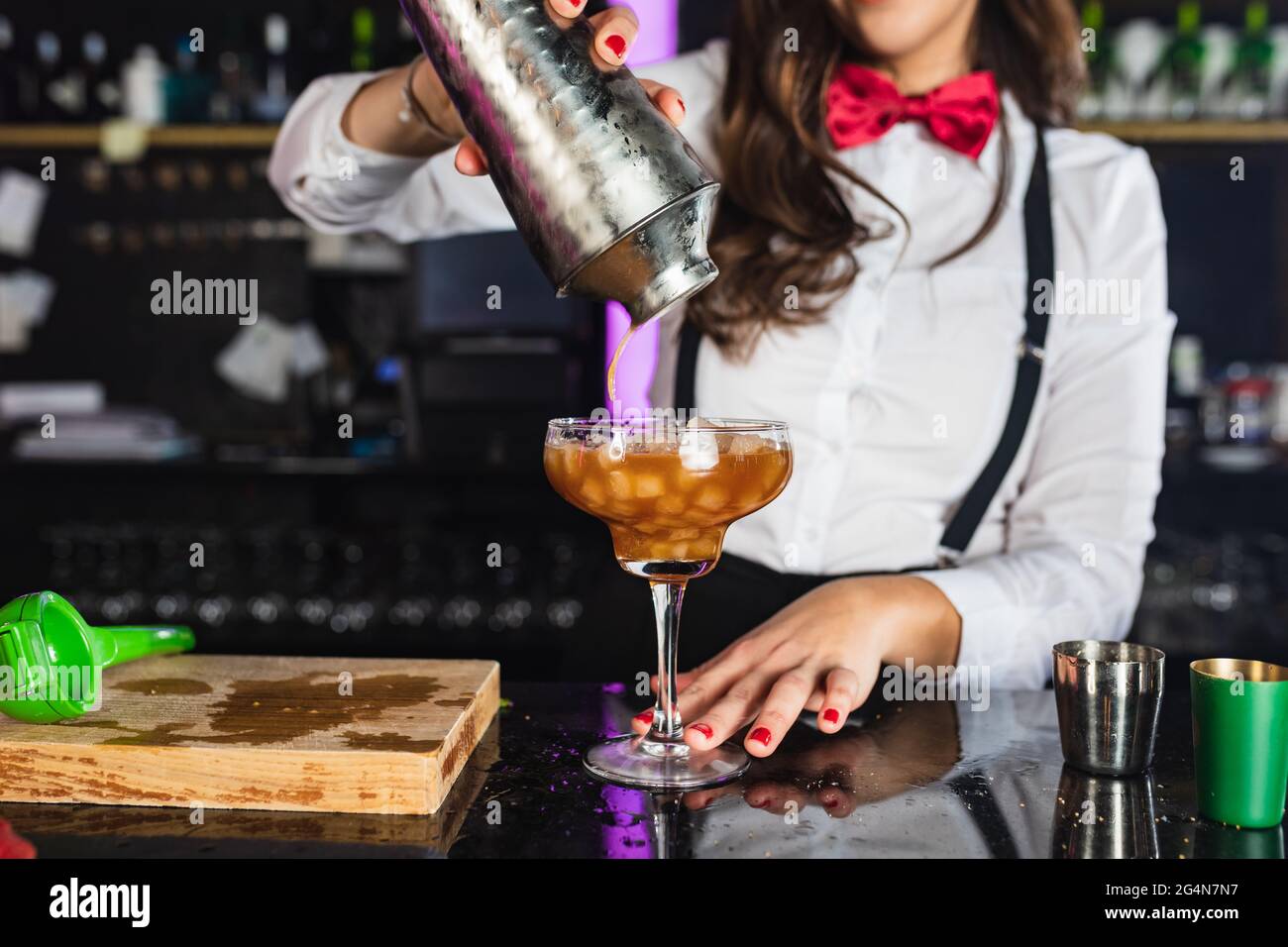 Cropped unrecognizable female barkeeper ...