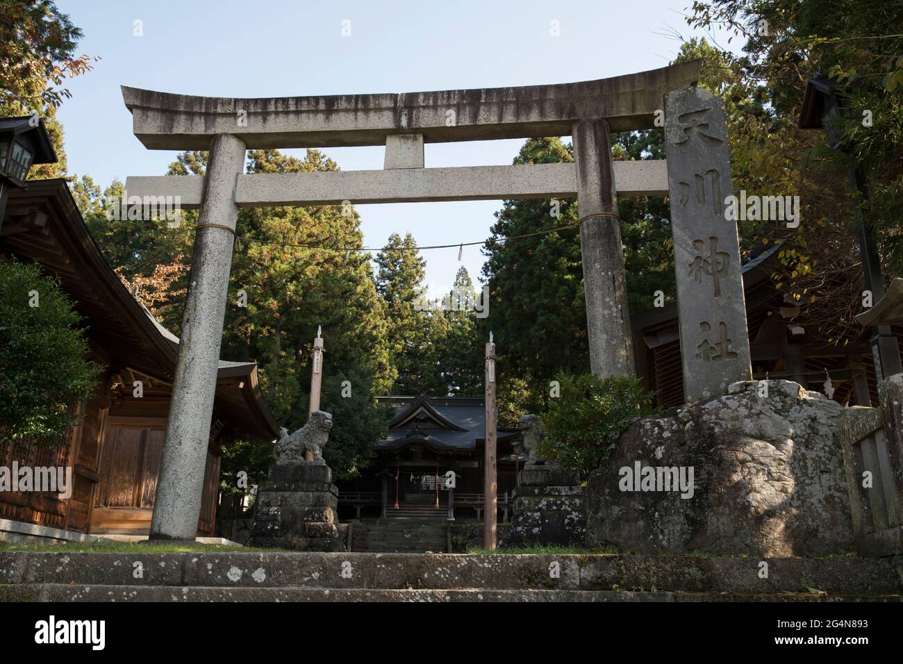 A small local temple with a torii gate in rural Japan Stock Photo