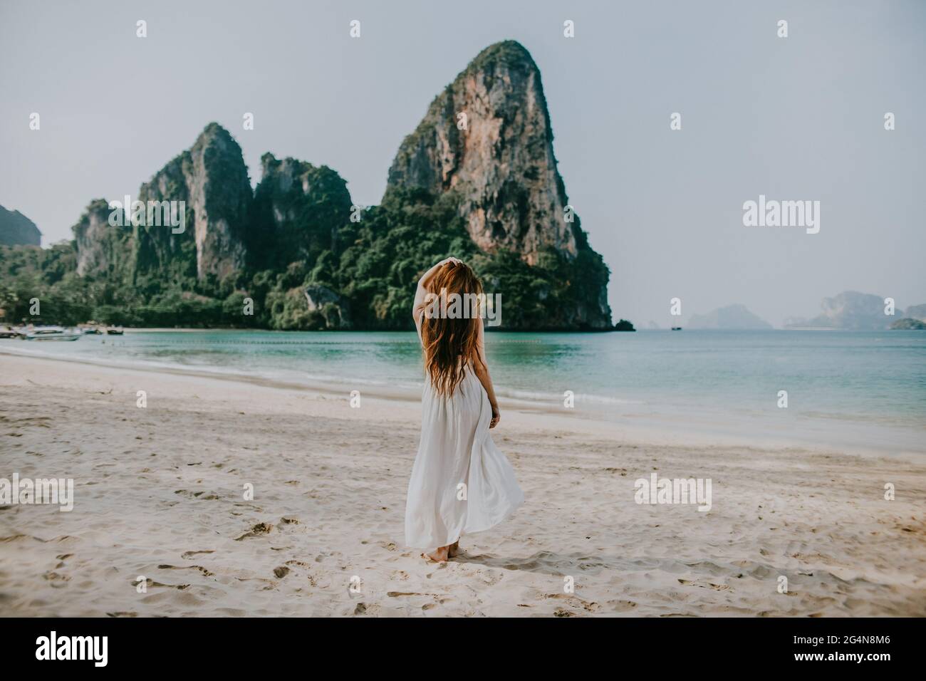 Young attractive sensual nude lady with masking tape on nipples holding  pistol in room Stock Photo - Alamy