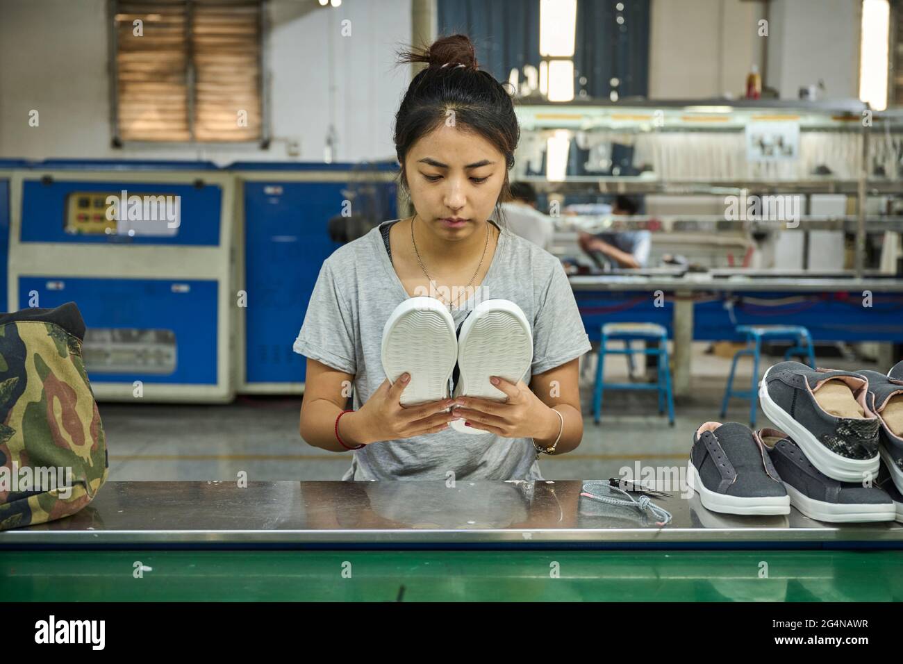 Employee doing quality control in Chinese shoes factory Stock Photo Alamy
