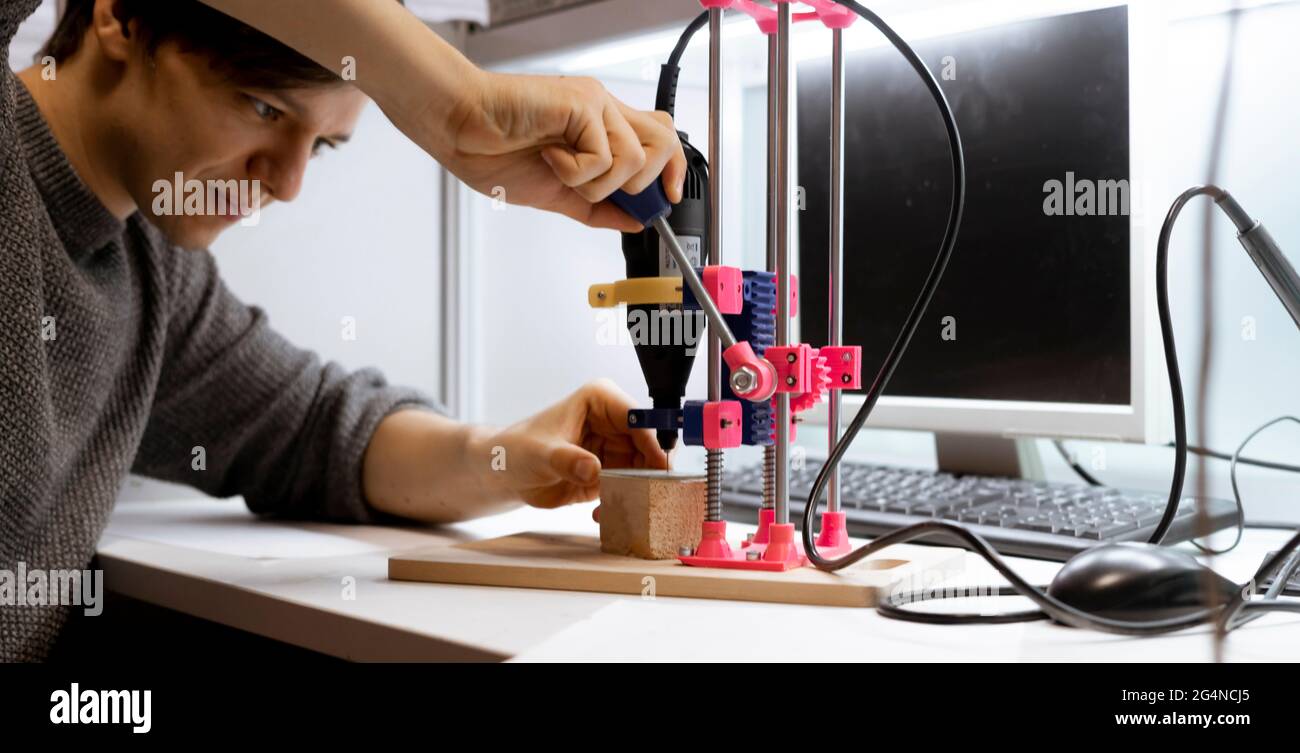 close up male engineer working in the laboratory, drilling the electric