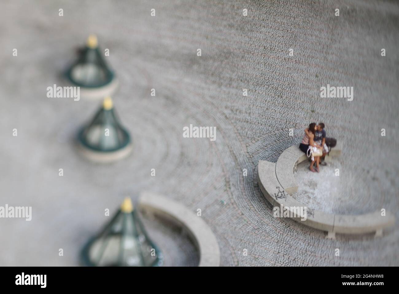 Couple kissing shot with tilt and shift lense making the people