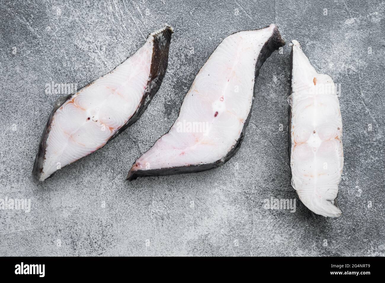 Slices of white fish seafood market set, on gray stone table background ...