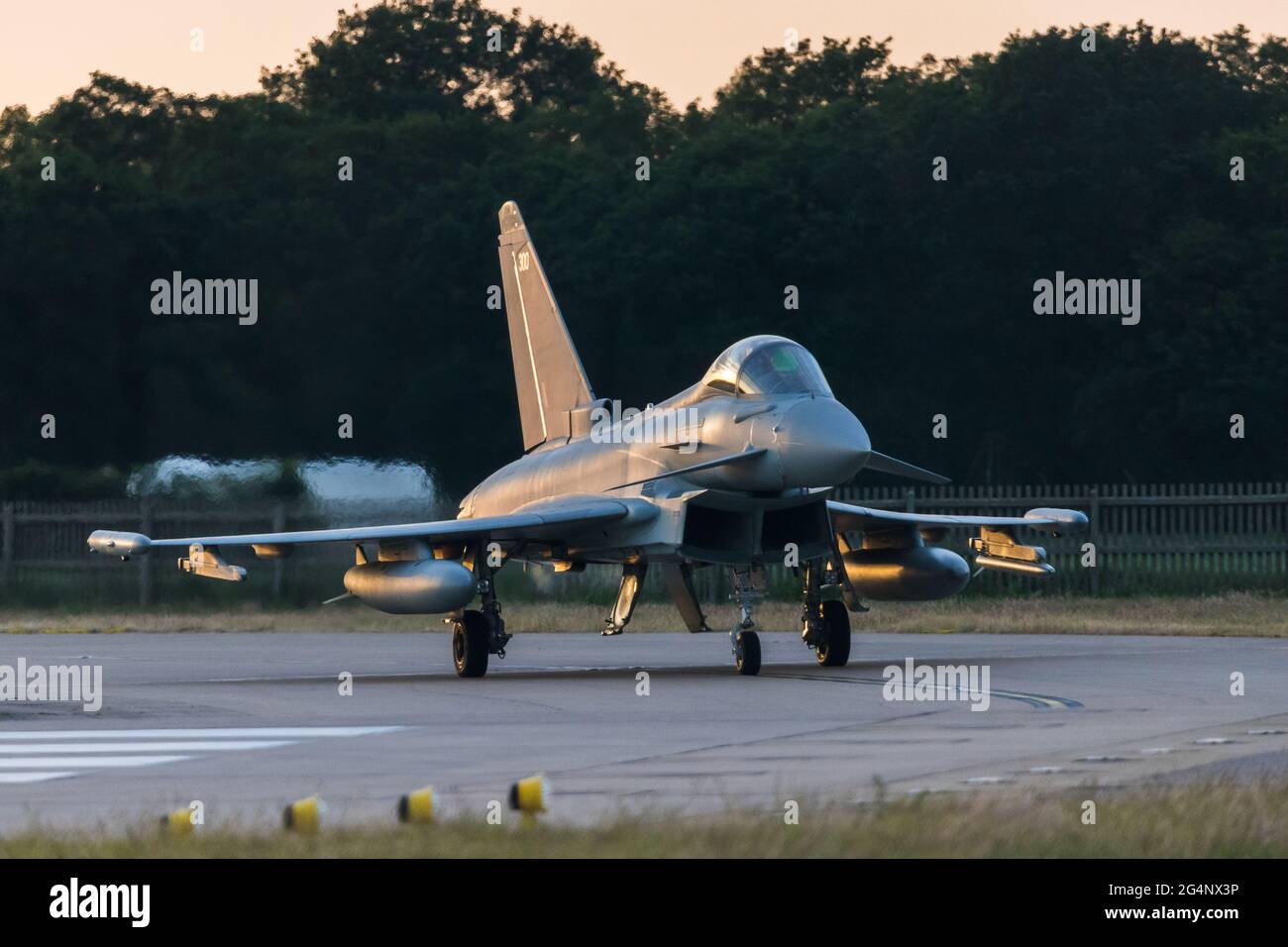 Eurofighter Typhoon nears the runway just before sunset in June 2021 at RAF Coningsby as it prepares to take off on a training sortie. Stock Photo