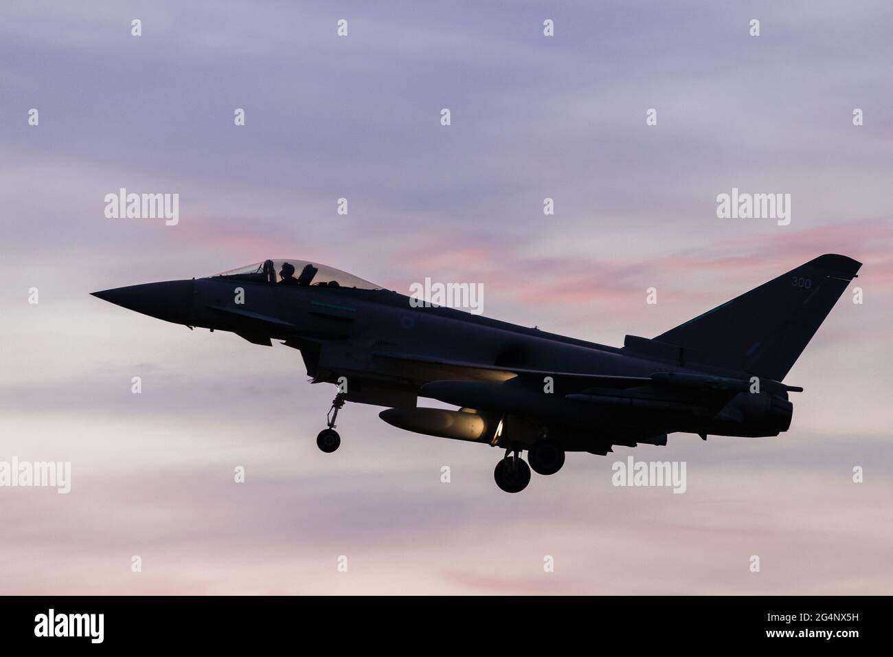 RAF Typhoon landing at RAF Coningsby during sunset after a training sortie in June 2021. Stock Photo