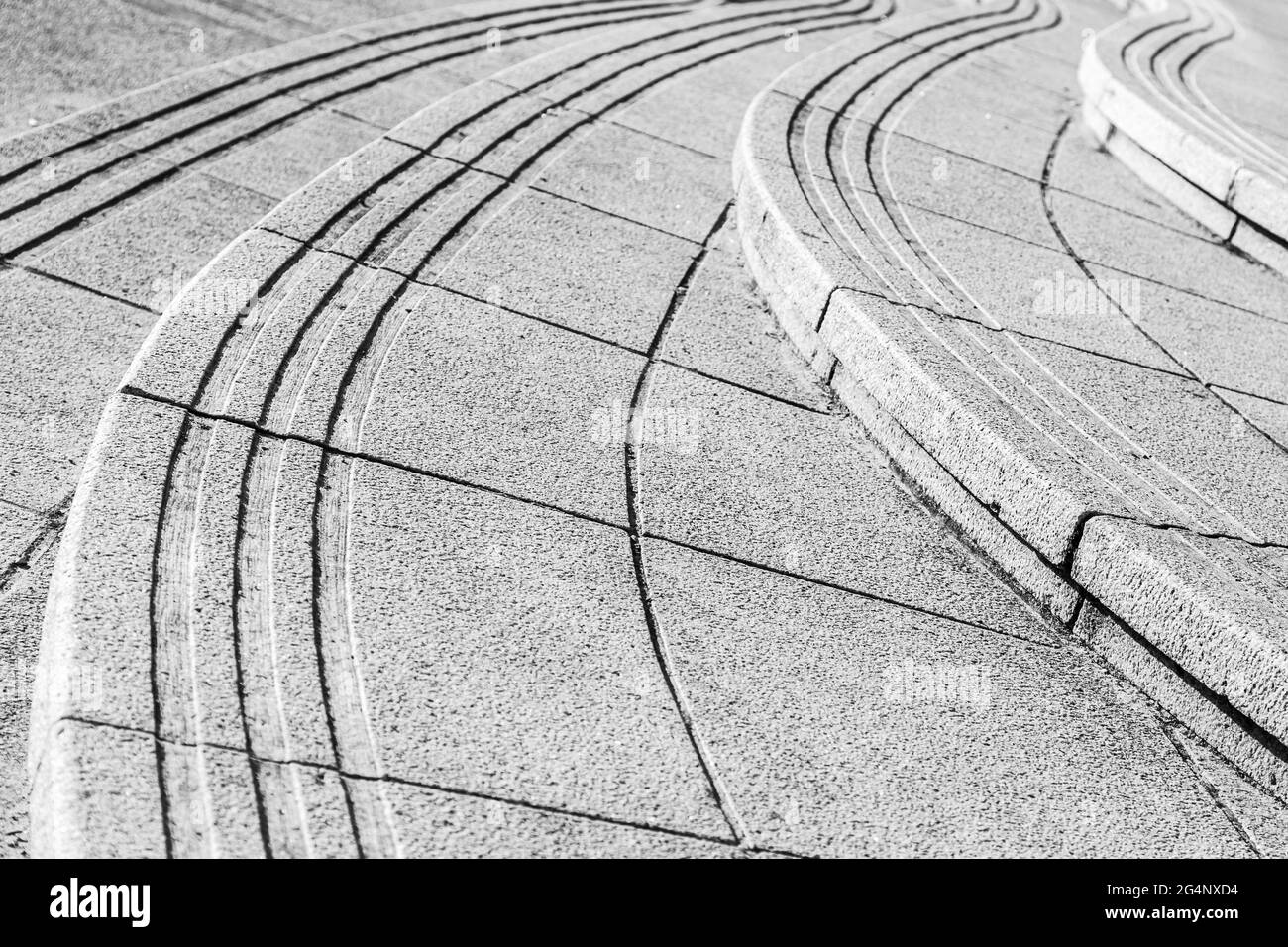 Monochrome image of curved paving leading to Cromer Pier in Norfolk. Stock Photo