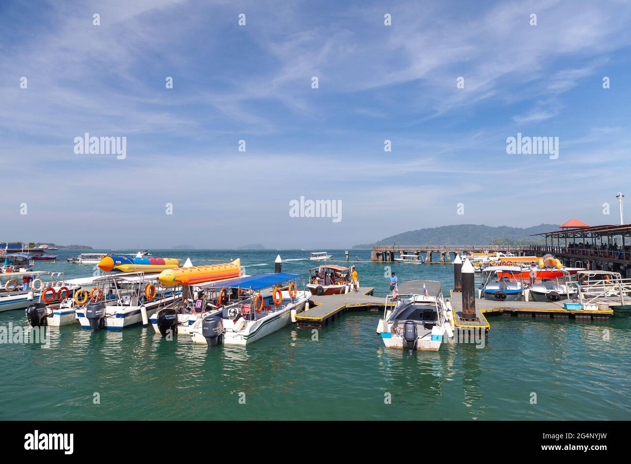 Kota Kinabalu, Malaysia - March 17, 2019: Small motorboats with passengers are near Jesselton Point ferry terminal at sunny day Stock Photo