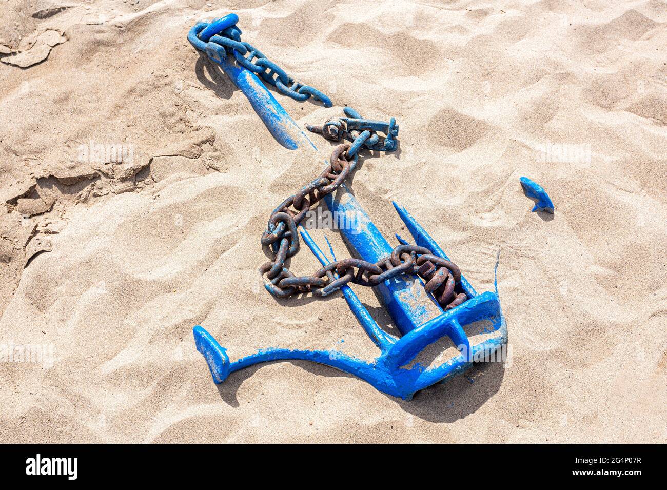 Old anchor ship with anchor chain on the sand beach Stock Photo