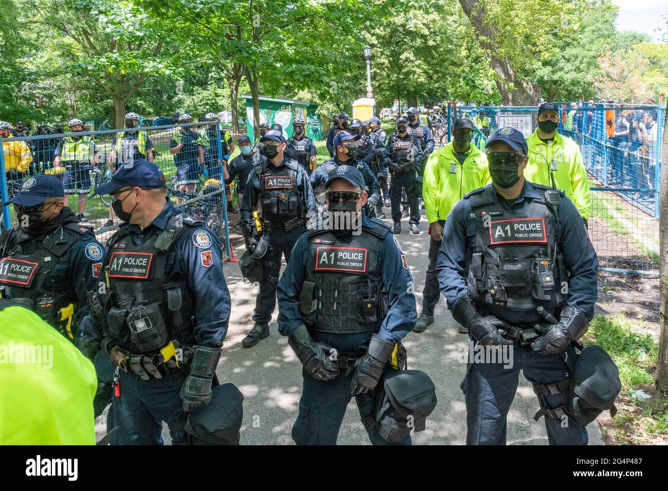 Toronto police and security forces clear out a homeless people encampment in Trinity Bellwoods Park, Canada. Stock Photo