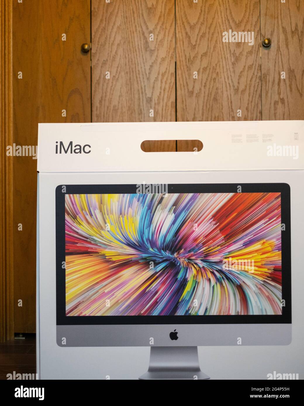 New 2020 model iMac box sitting on the floor after delivery. Stock Photo