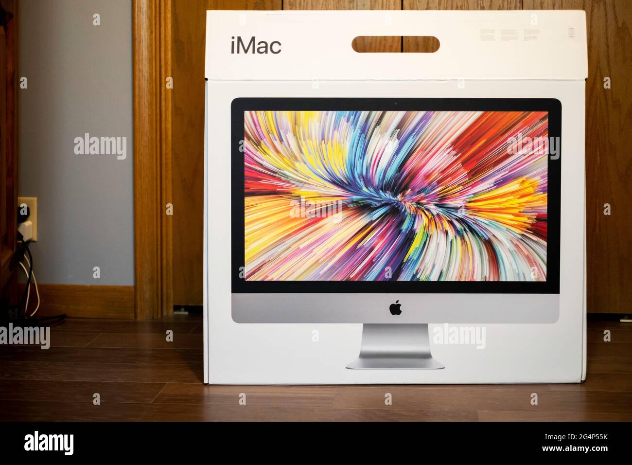 New 2020 model iMac box sitting on the floor after delivery. Stock Photo