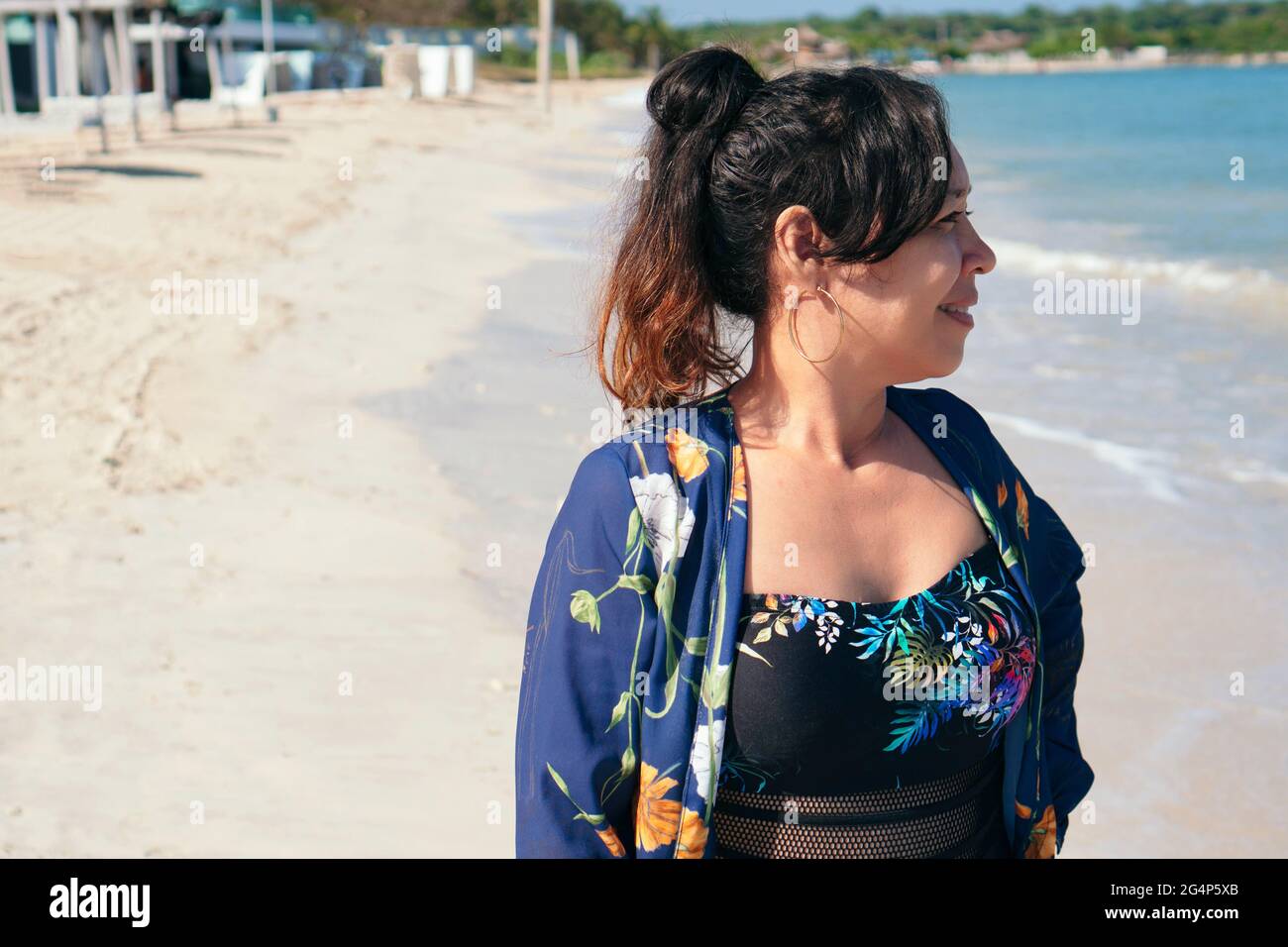 Mature woman enjoying herself on the beach Stock Photo - Alamy