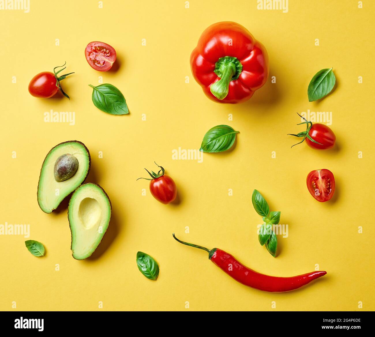 flat lay composition of various fresh raw vegetables on yellow background, top view Stock Photo