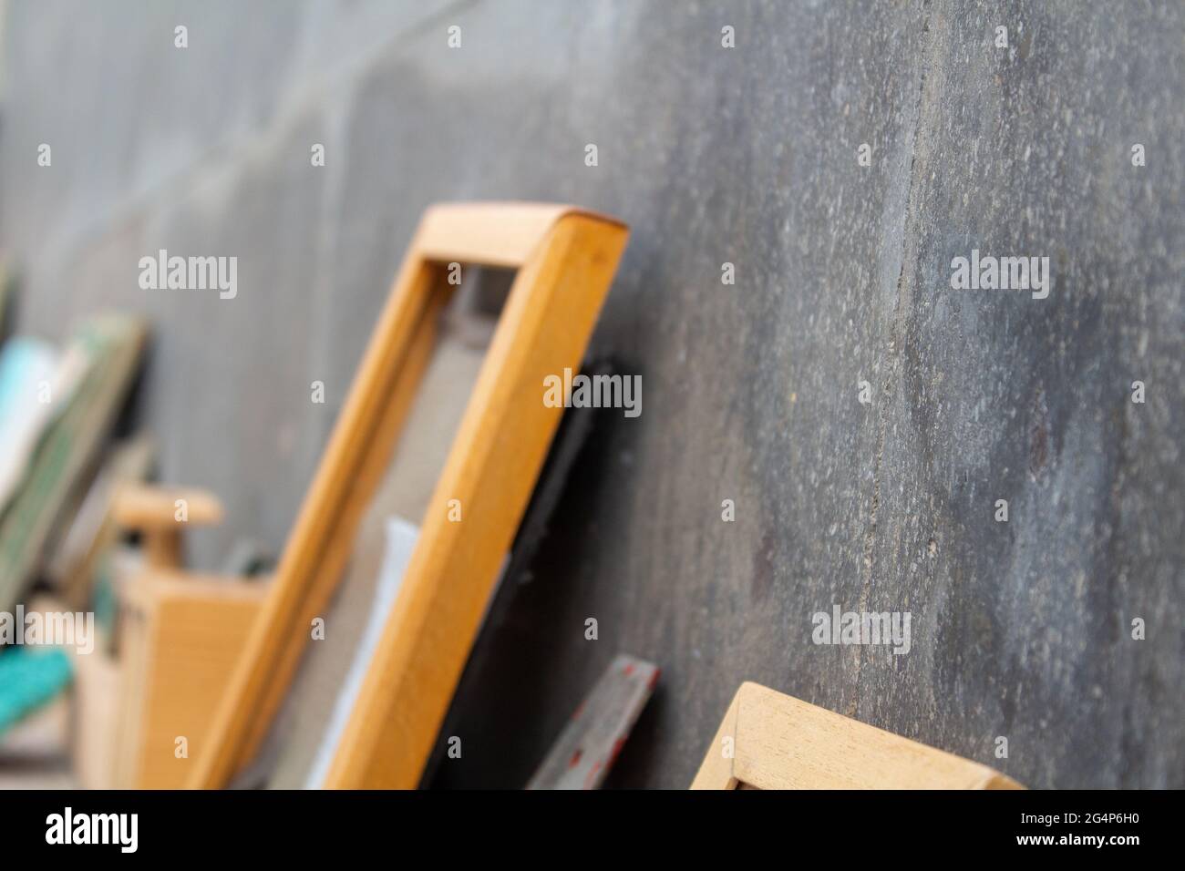 Selective focus shot of wooden frames leaning on a black wall Stock ...