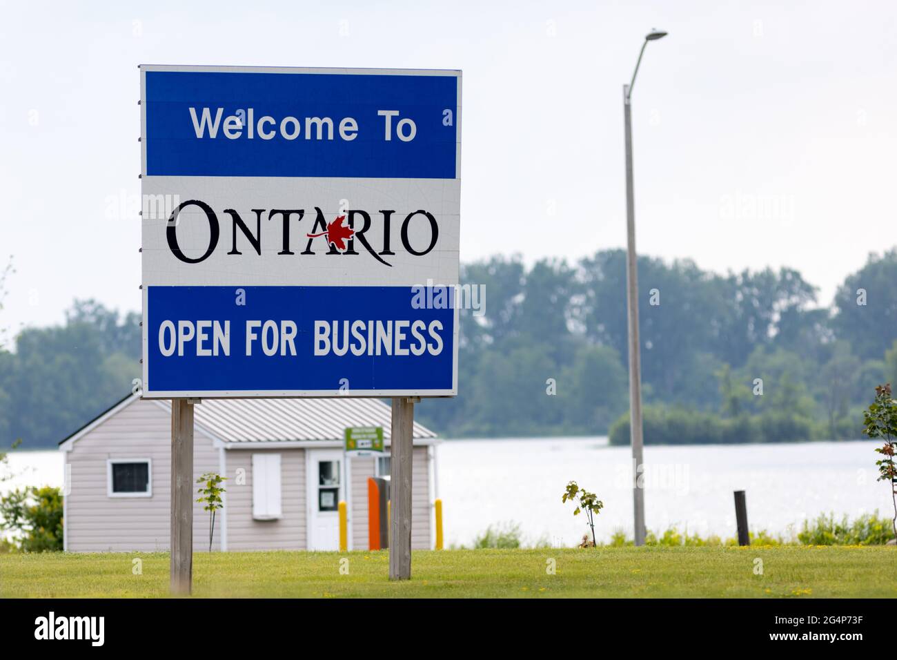 Hawkesbury, Ontario, Canada - June 21, 2021: A sign on Ile de Chenail welcomes motorists crossing from Grenville, Quebec to Ontario with the 'Open for Stock Photo