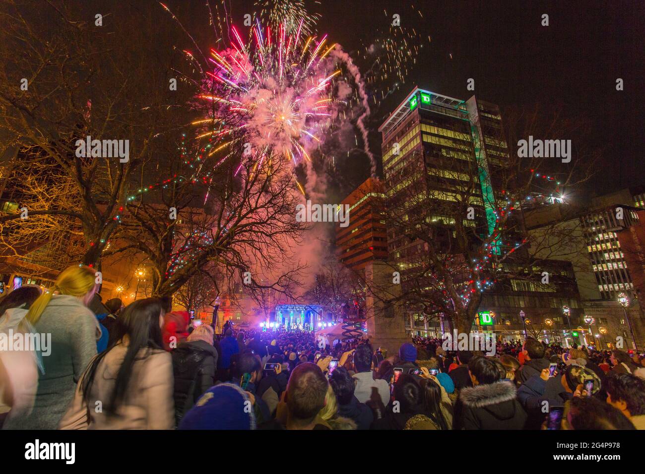 Halifax Downtown Fireworks with cheering background crowd. Beautiful fireworks on new year day at the City Hall (Grand Parade). Nova Scotia, Canada Stock Photo