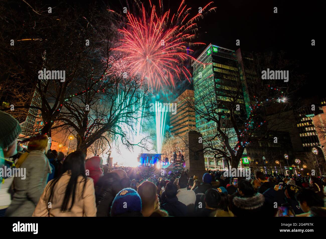 Halifax Downtown Fireworks with cheering background crowd. Beautiful fireworks on new year day at the City Hall (Grand Parade). Nova Scotia, Canada Stock Photo