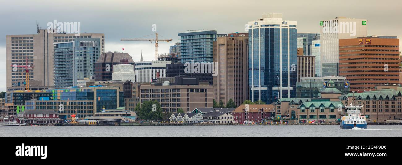 Halifax Harbor front with prominent business and financial buildings along with regional ferry. Halifax Skyline as seen from Dartmouth. Nova Scotia Stock Photo