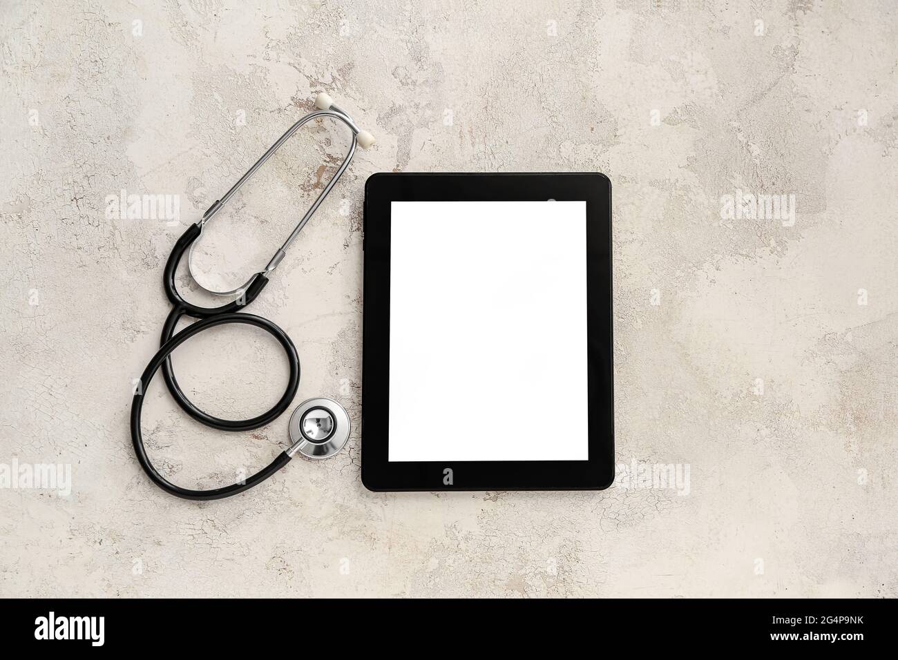 Tablet computer with stethoscope on grunge background Stock Photo - Alamy