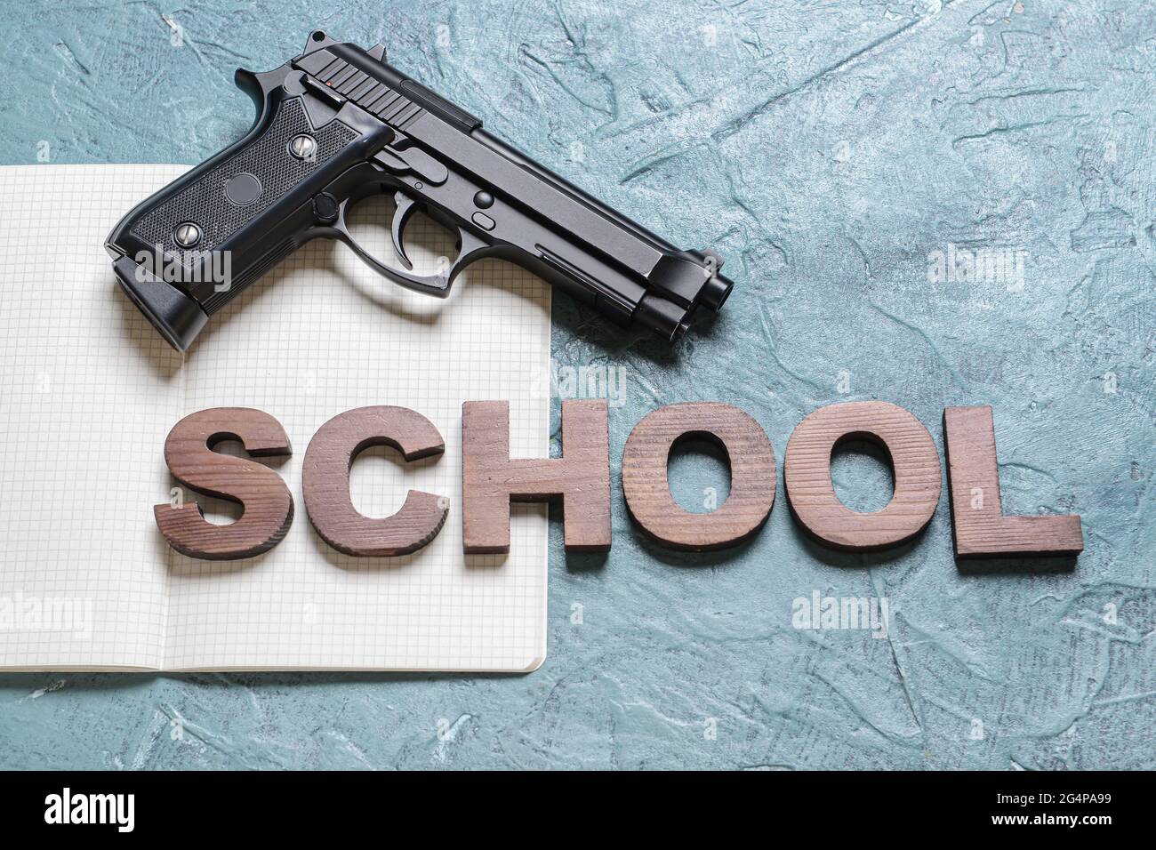 Pistol and notebook on color background. Concept of school shooting ...