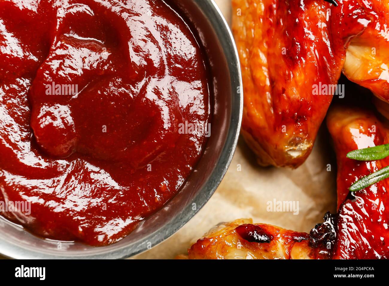 Chicken wings and pot with barbecue sauce, closeup Stock Photo Alamy