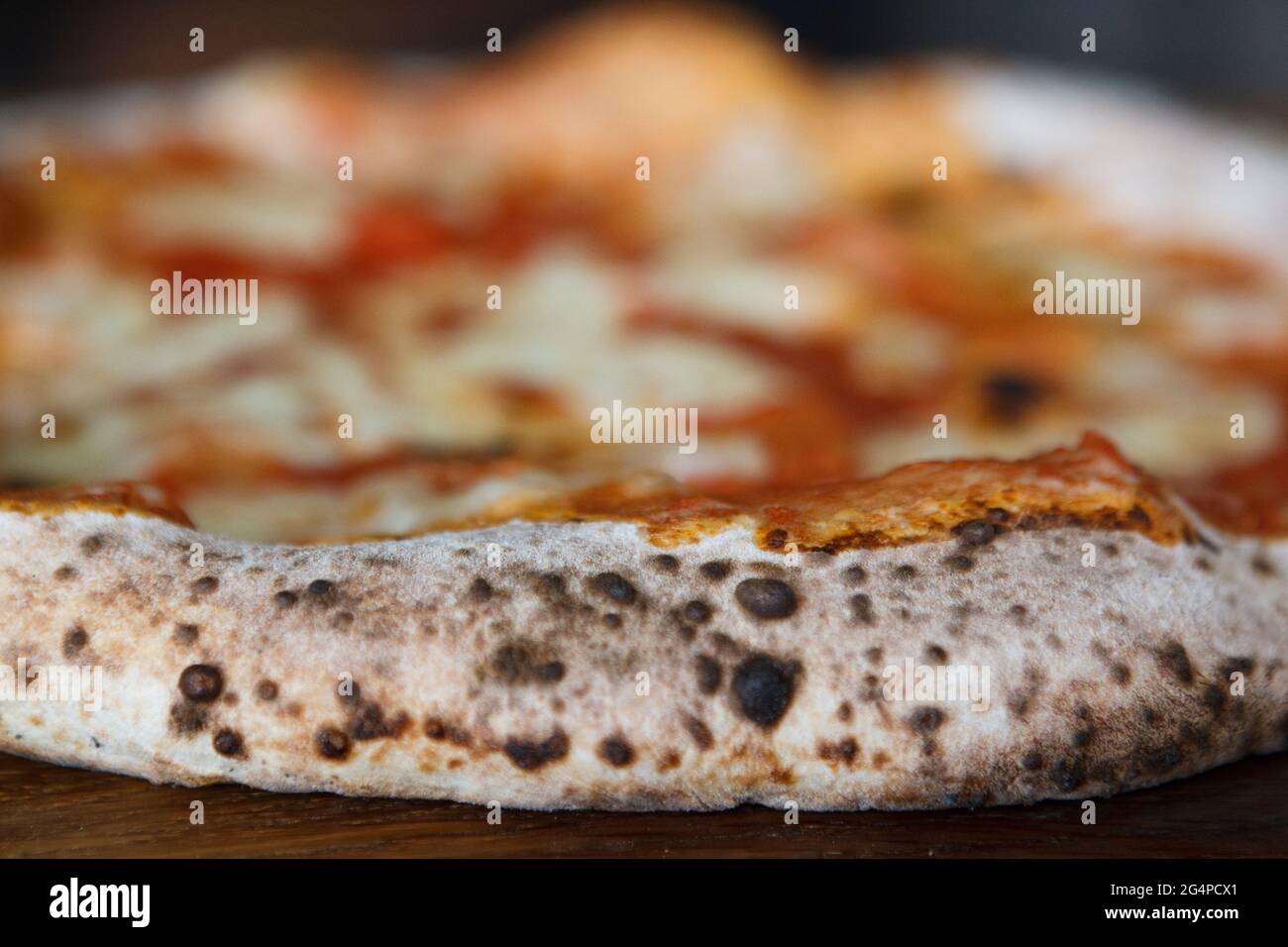 Italian pizza Napoletana on wooden table, selective focus Stock Photo