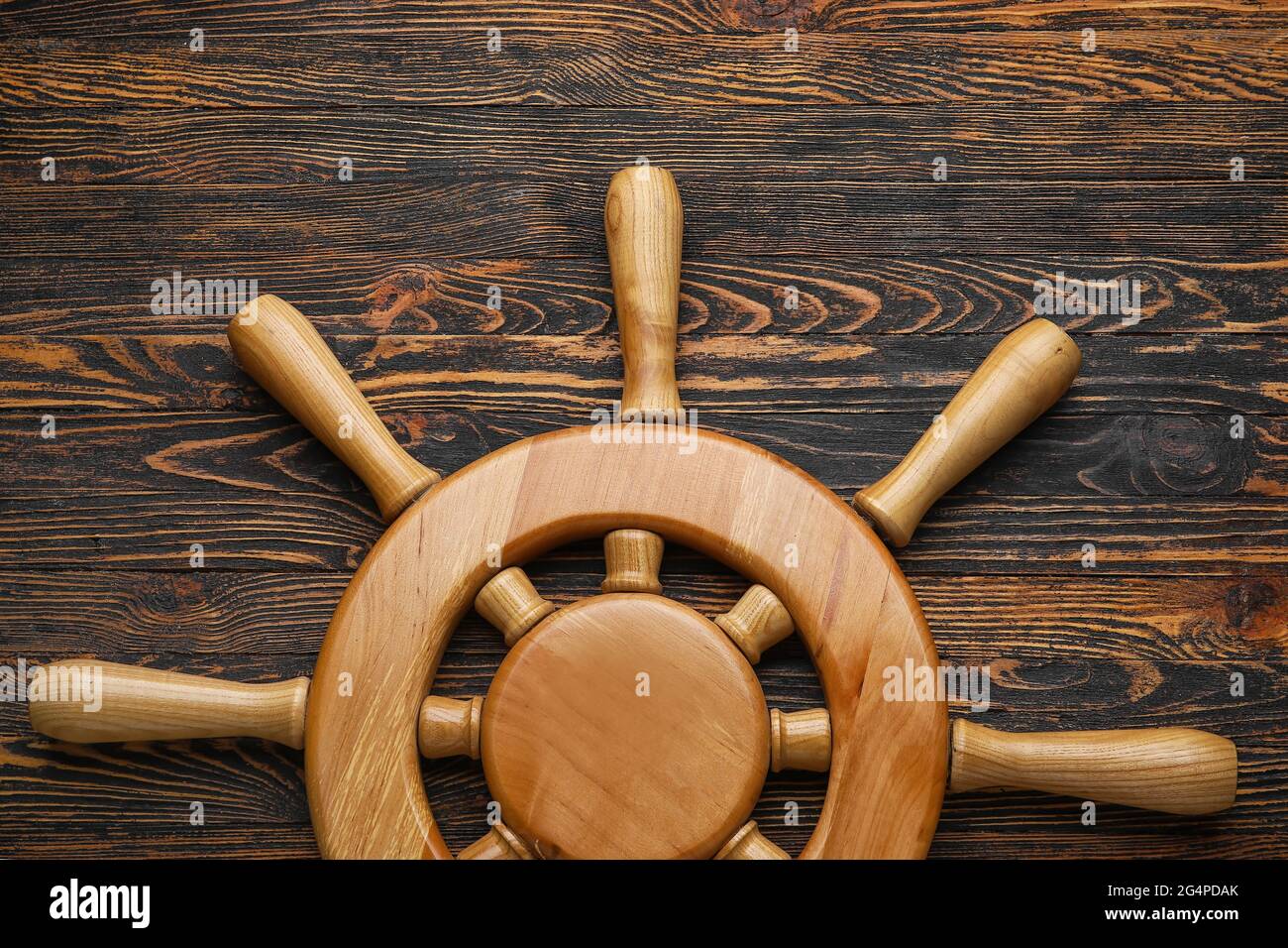 Ship helm on wooden background Stock Photo - Alamy