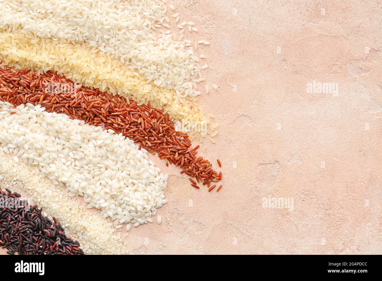 Different types of raw rice on color background Stock Photo - Alamy