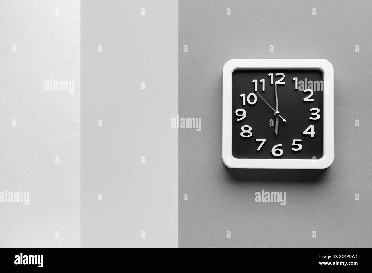 Stylish clock on grey background Stock Photo - Alamy
