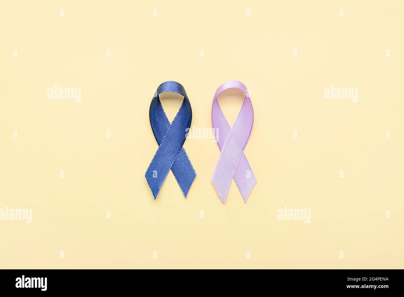 Lilac and blue ribbons on color background. Cancer awareness concept Stock Photo