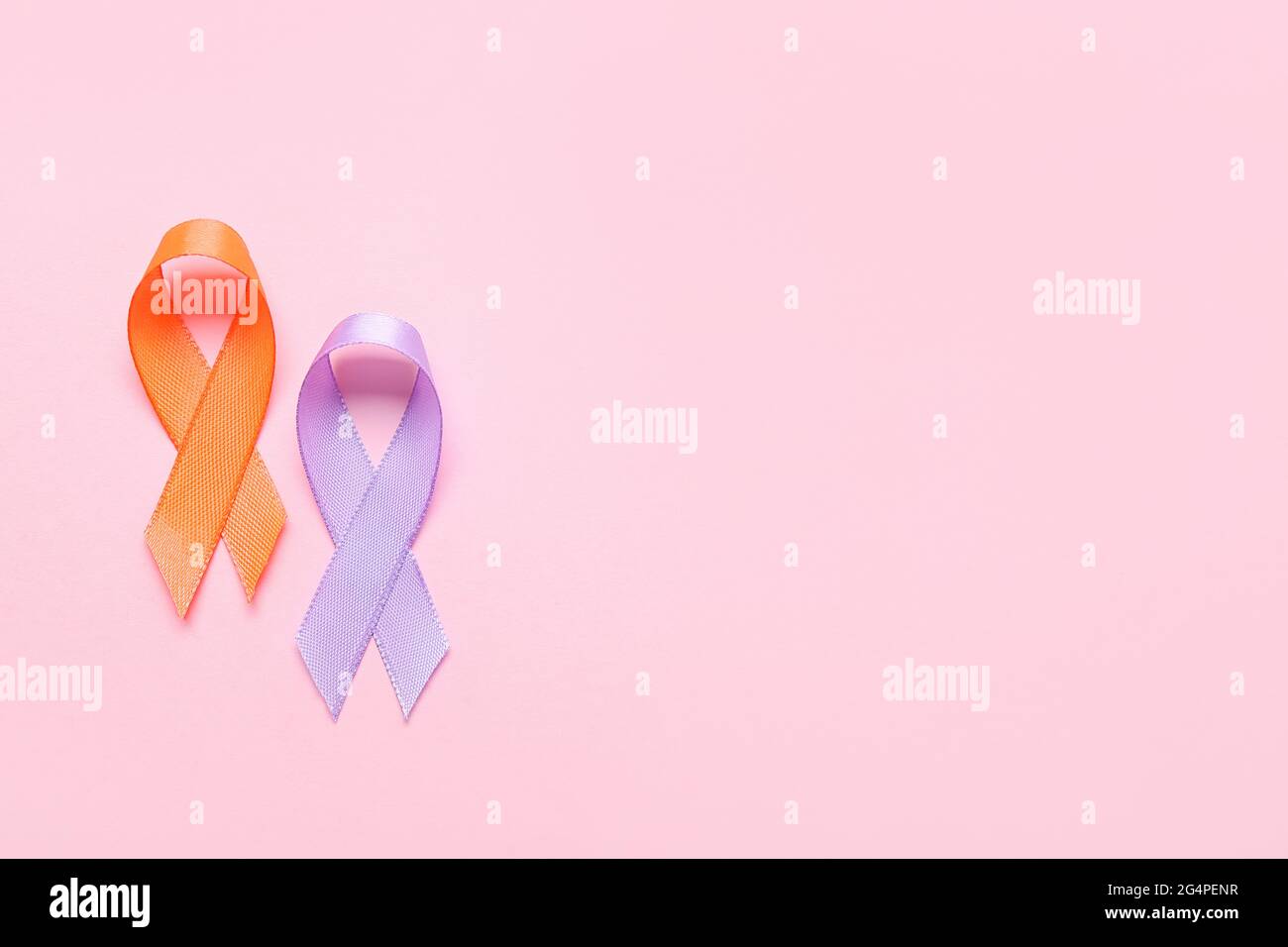 Orange and lilac ribbons on color background. Cancer awareness concept Stock Photo