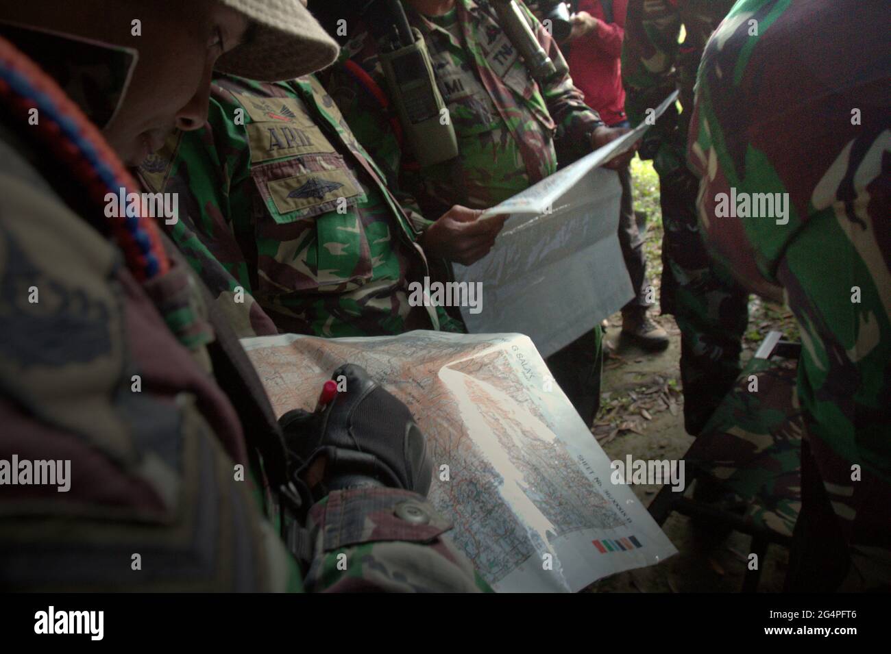 Mount Salak, West Java, Indonesia. May 10, 2012. Military personnels reading maps before the search mission for the Sukhoi Superjet 100 (SSJ-100) plane that crashed on May 9. Stock Photo