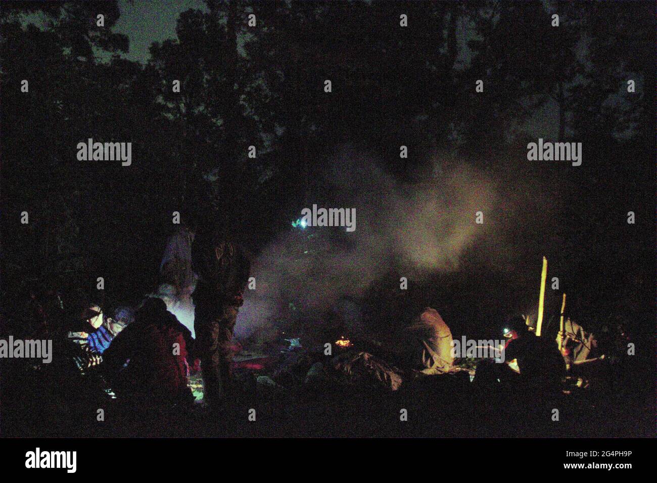 Mount Salak, West Java, Indonesia. May 11, 2012. Search and rescue personnels cooking while resting, during the search mission for the Sukhoi Superjet 100 (SSJ-100) plane that crashed in the region on May 9. Stock Photo