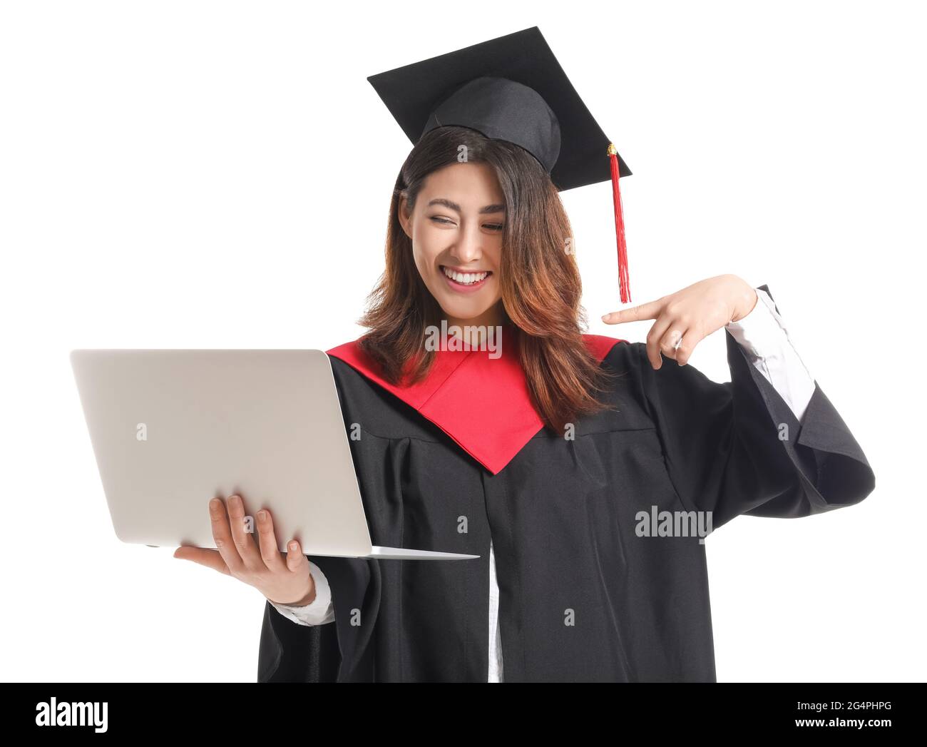 Female graduating student with laptop on white background Stock Photo ...