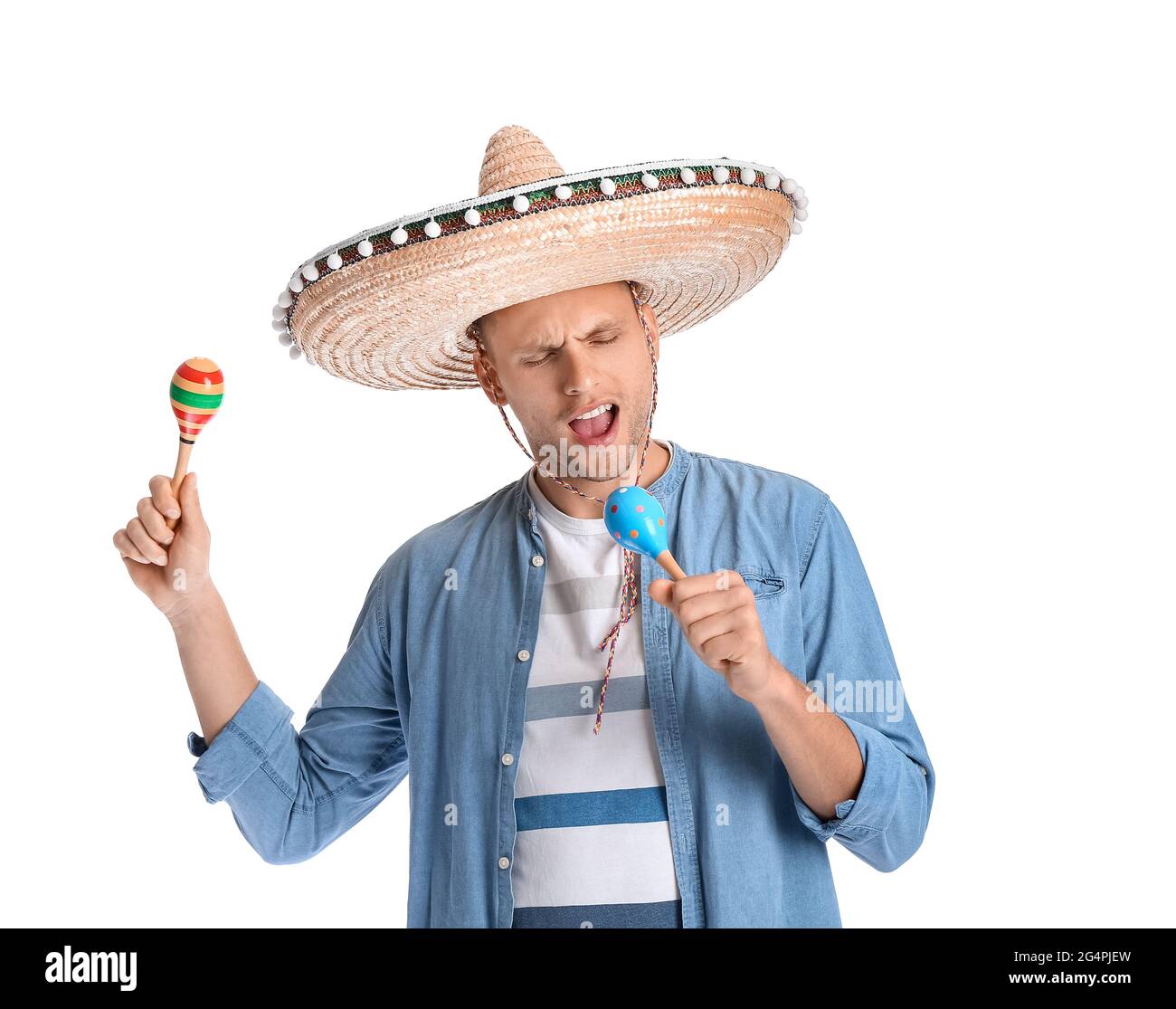 Happy young Mexican man in sombrero hat and with maracas on white  background Stock Photo - Alamy