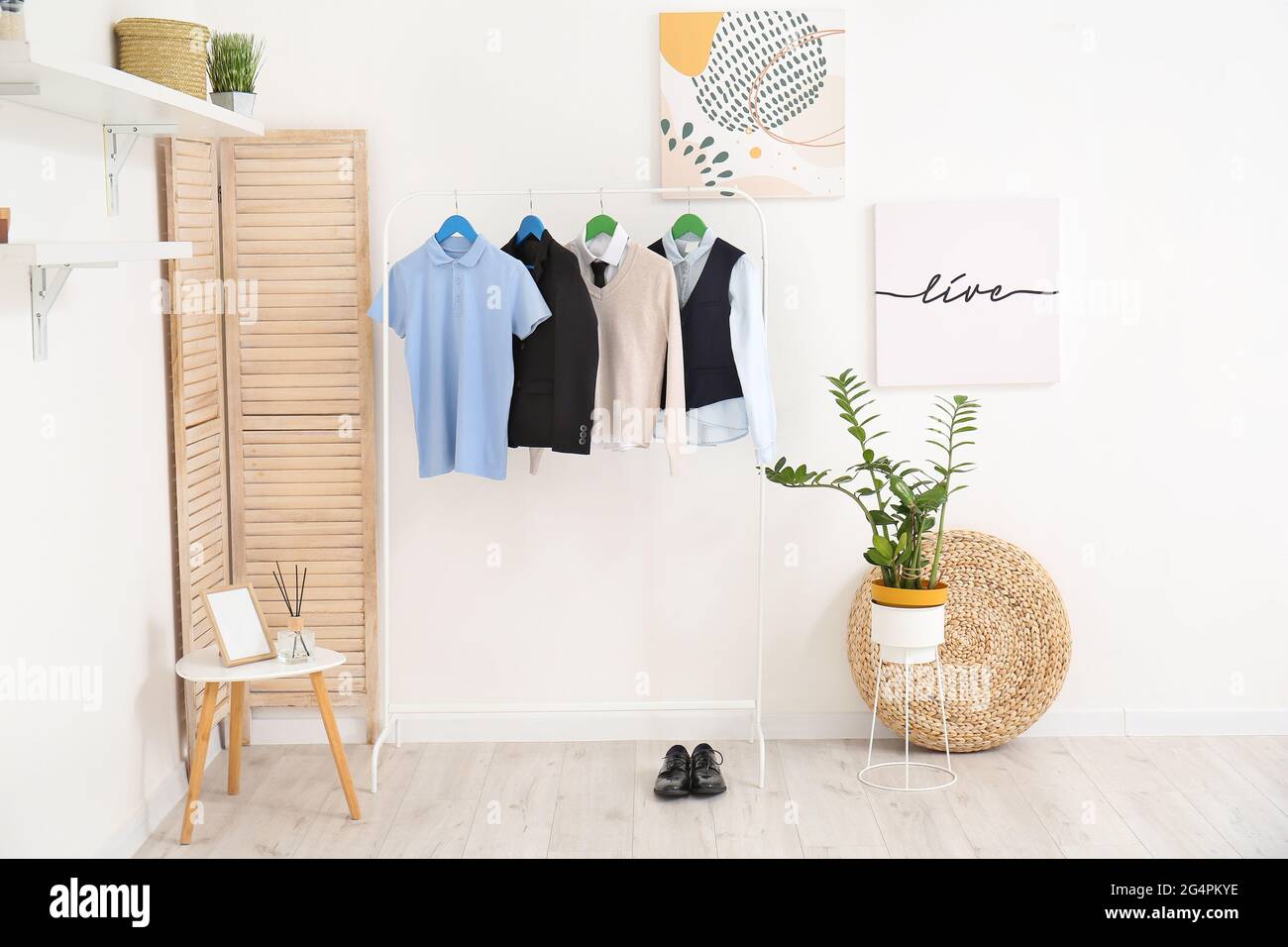 Rack with stylish school uniform in interior of room Stock Photo - Alamy