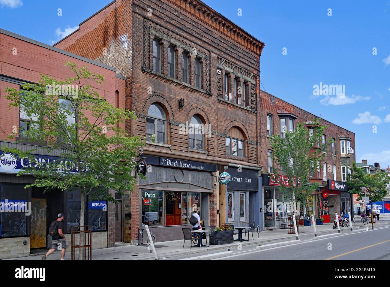 Toronto, Canada - Bloor Street, a trendy neighborhood of downtown Toronto, with local shops and pubs in buildings dating from the 1890s. Stock Photo