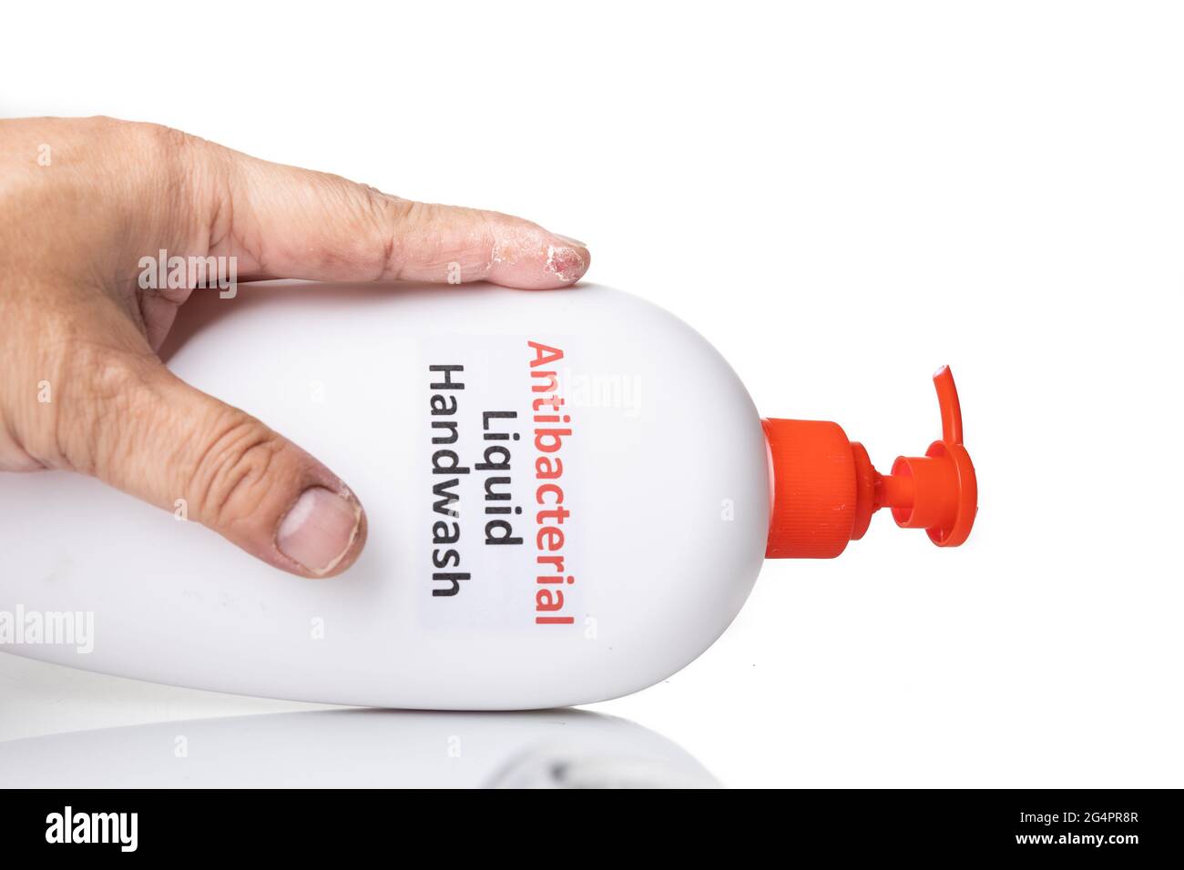 Dry skin on finger with bottle of antibacterial liquid handwash