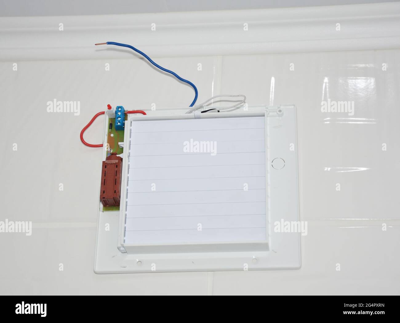 Bathroom ventilation fan, exhaust fan installation on a tiled wall