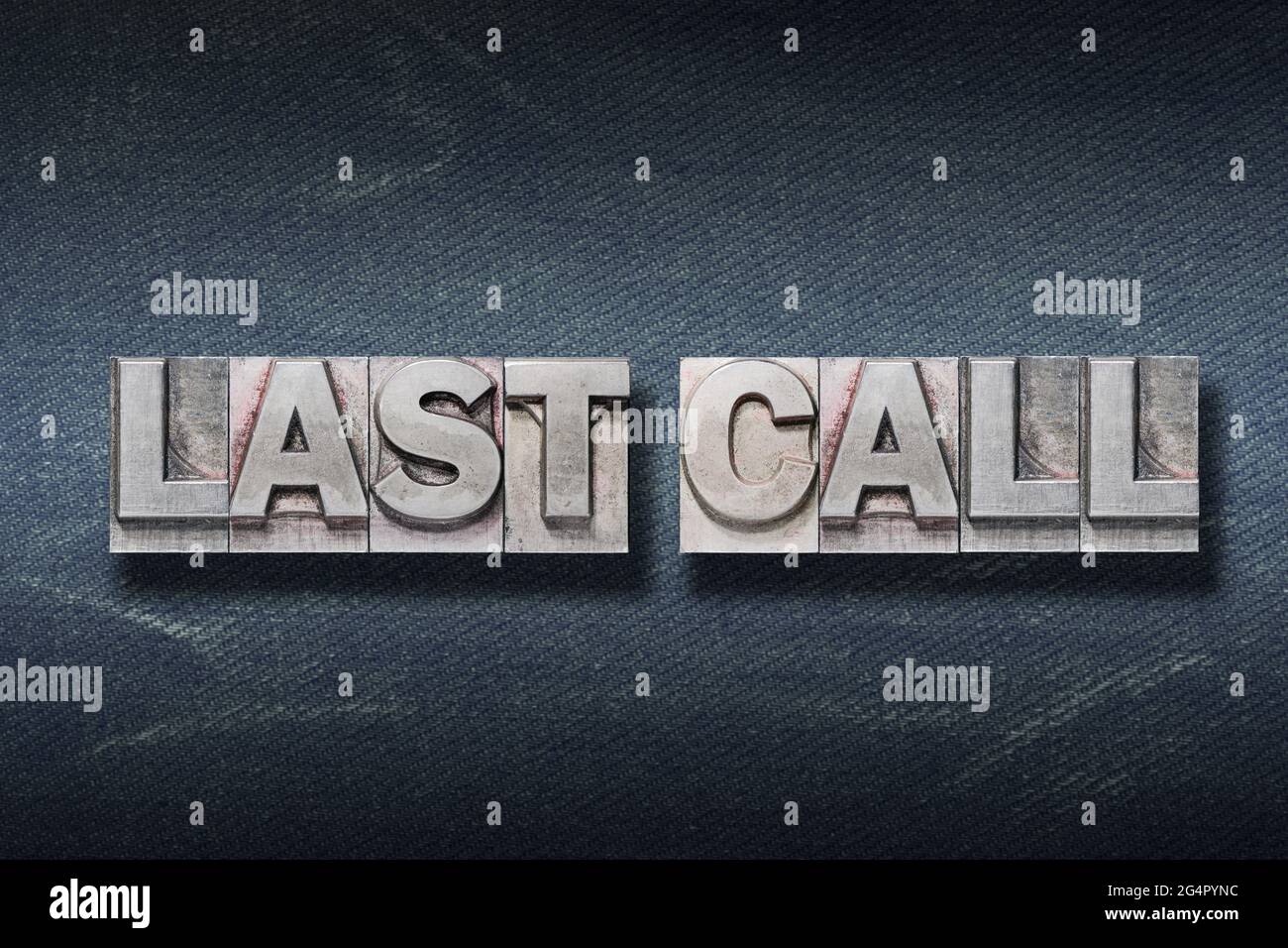last call phrase made from metallic letterpress on dark jeans background Stock Photo