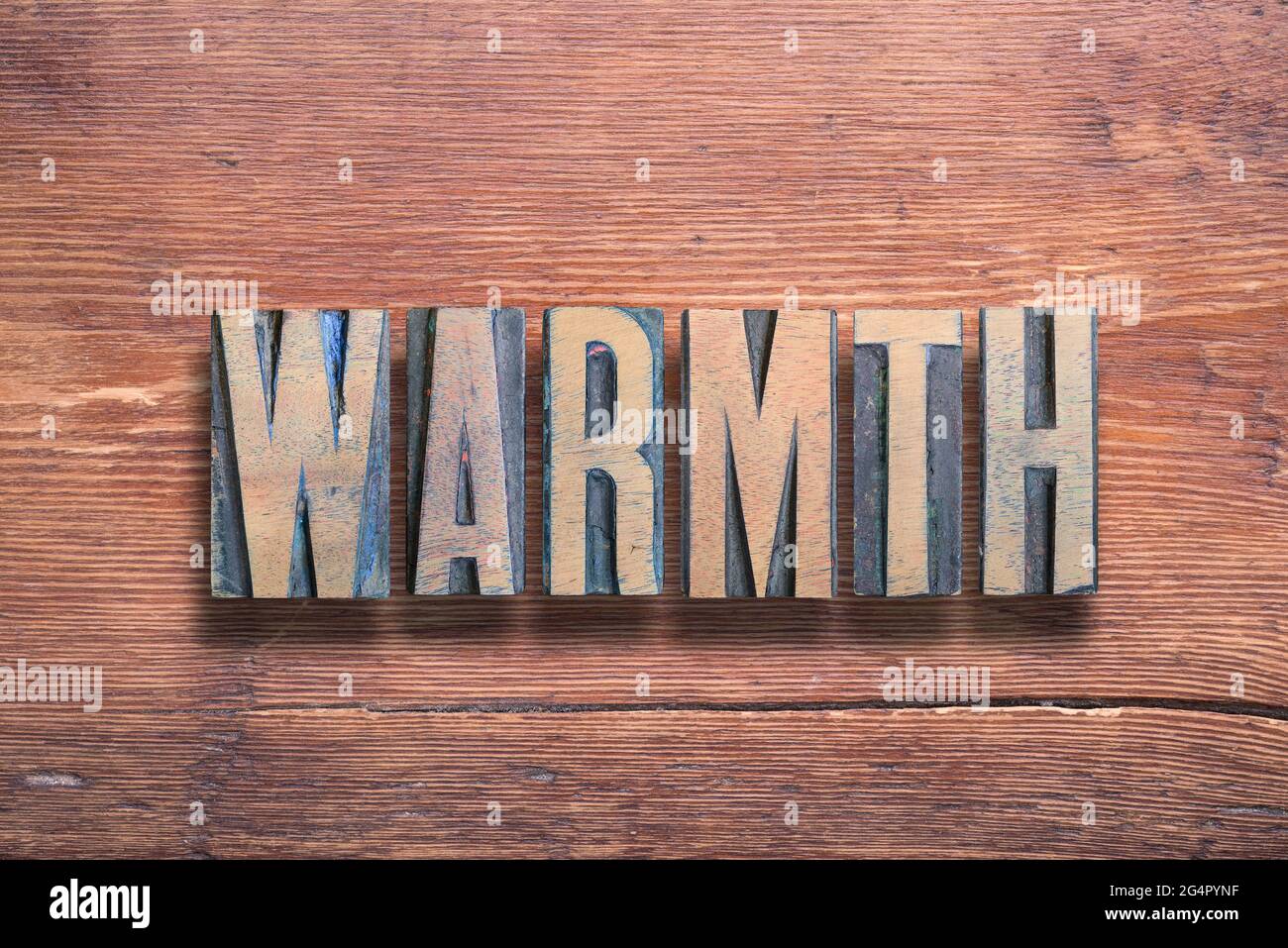 warmth word combined on vintage varnished wooden surface Stock Photo