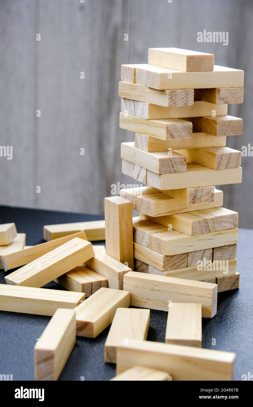 Building from wooden blocks. Wood blocks stack game with Hand on ...